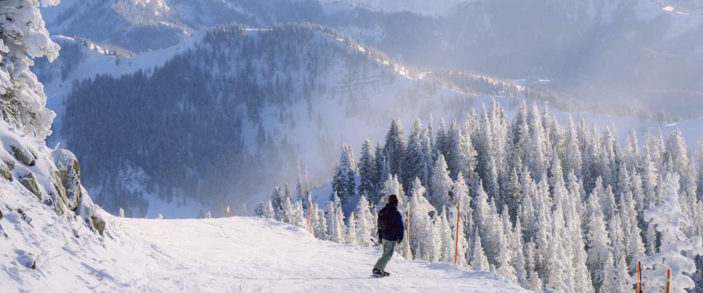 Snowboarder going down the Great Western at Brighton Resort, UT.