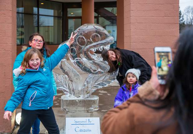 People posing for pics in front of sculptures at the Clarks Summit Festival of Ice