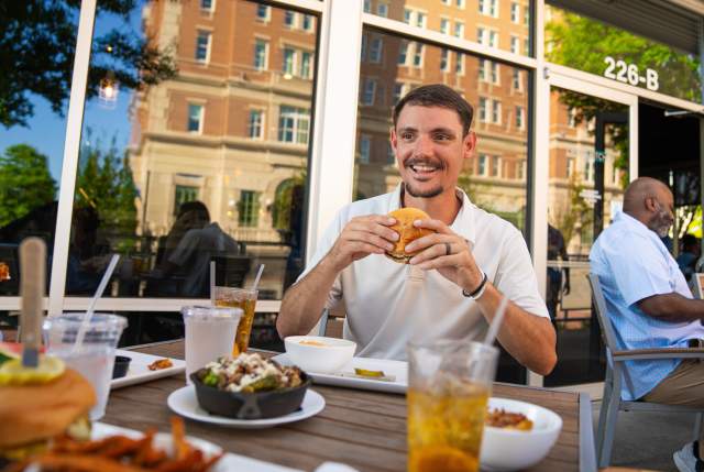 Man eating burger from Cribb's Kitchen