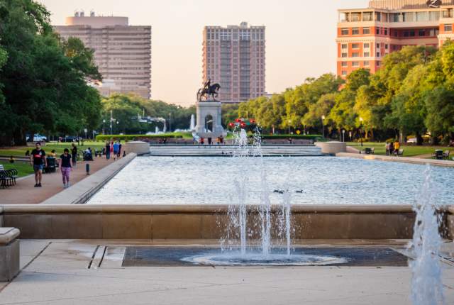 People walking around Hermann Park on a sunny afternoon