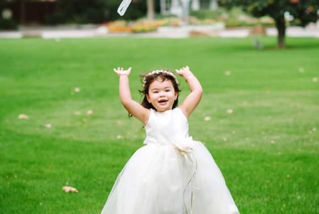 Wedding flower girl throws bouquet