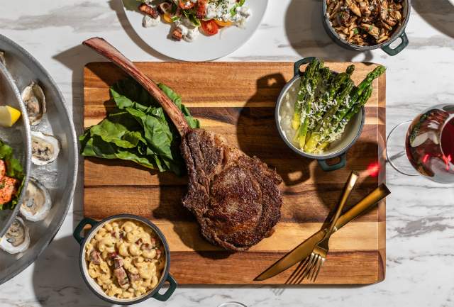 Overhead shot of meat and vegetables on a cutting board at Le Moyne's Chophouse in Mobile, AL things to eat