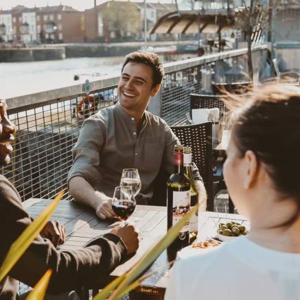 Friends drinking wine on the terrace at Harbour House