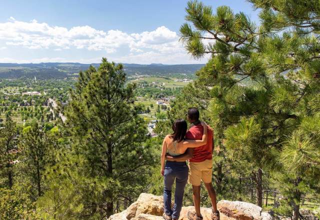 Hikers enjoying the scenic overlook of rapid city from the trails of skyline wilderness area