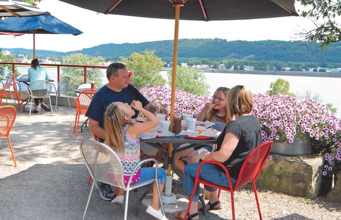 A family eats lunch at a local restaurant overlooking a river.