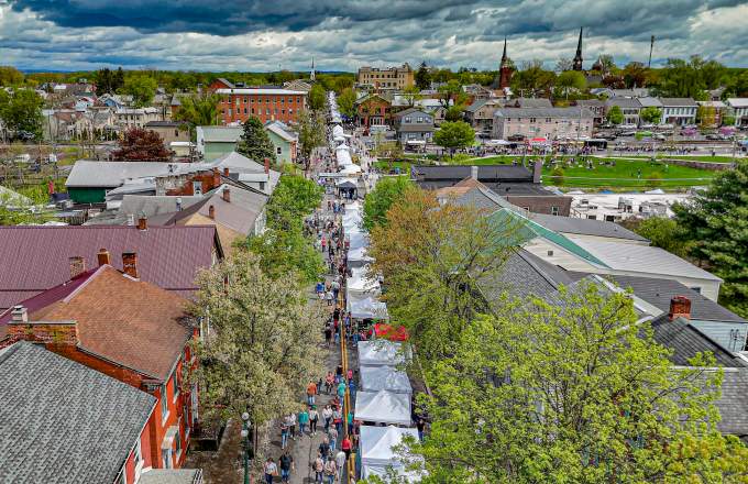 Picture of Lewisburg Arts Festival from an ariel perspective looking down market street above the vendor tents.