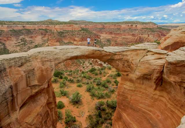 Hiking across an arch in Rattlesnake Canyon