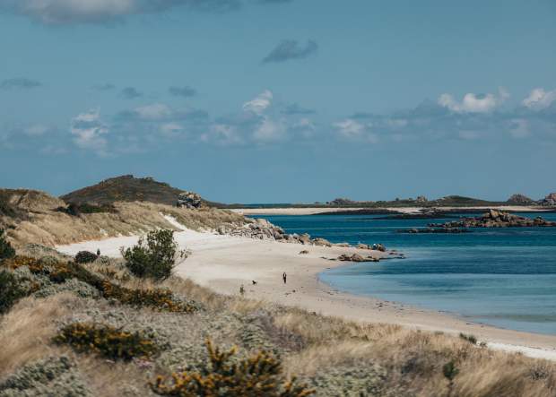 Walking along a beach on Tresco