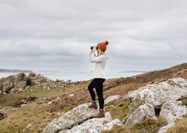 Lady with binocs stormwatching in winter