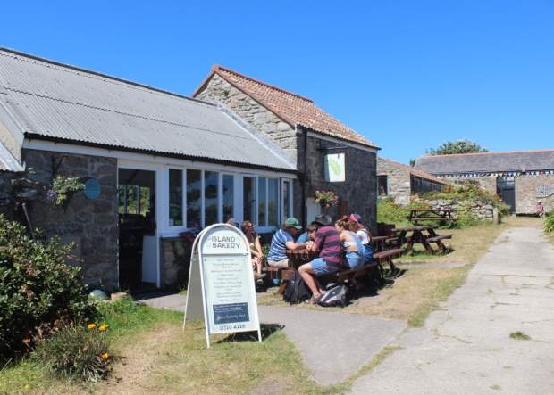 People eating outside The Island Bakery on St. Martin's