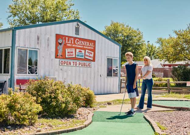 Family playing mini golf