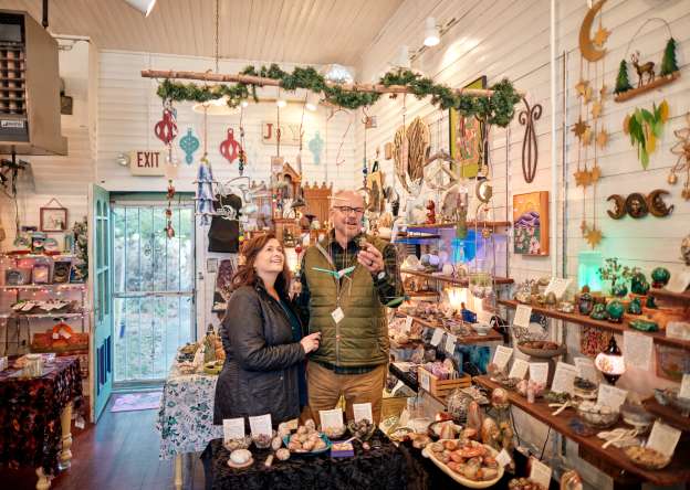 Two people looking at items in a shop, at Nature's Treasures.