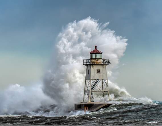 Storm Season - wave breaking over lighthouse - by David Johnson