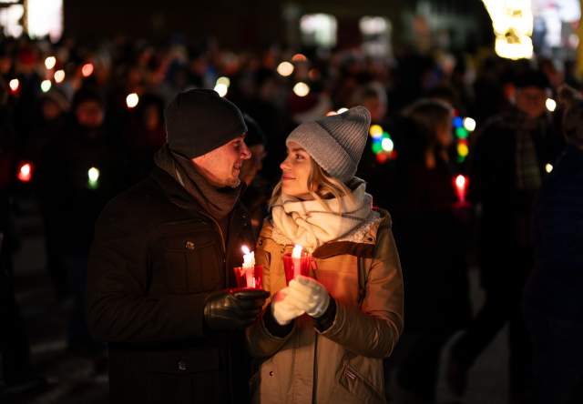 Couple holding candles in the dark