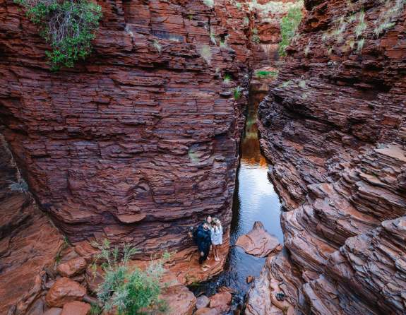 hikers looking at the walls of a gorge in Karijini National Park