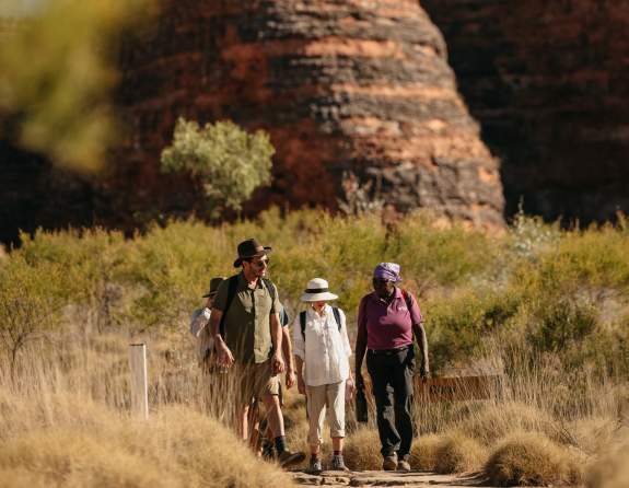 A guide from Kingfisher Tours takes a couple through the striped domes of the Bungle Bungle Ranges