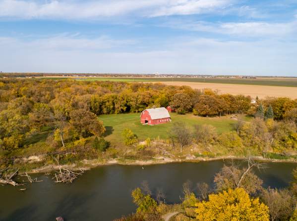 Aeriel of the Red River with fall foliage and a red barn