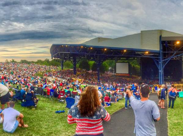 A group of people at an outdoor concert during the day