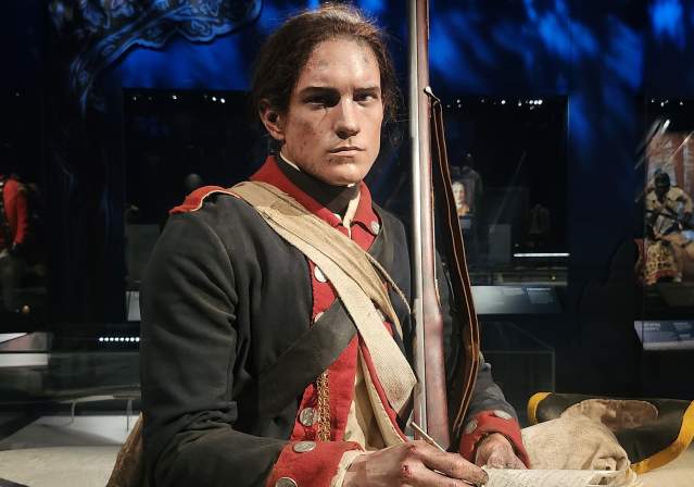 Wax Figure of a Single Male Soldier Writing during the Revolutionary War.