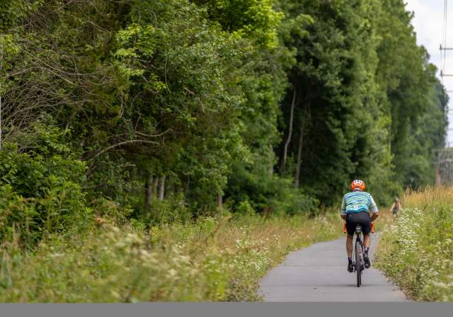 man riding a bike on the cross county trail.