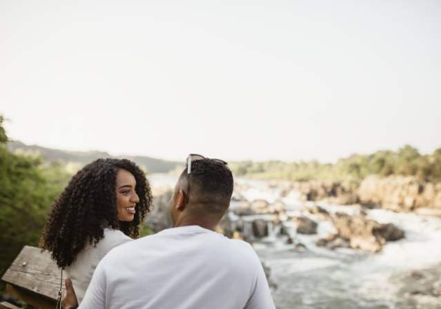 Couple Gazing Lovingly at One Another Overlooking GreatFalls