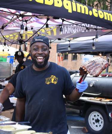 Man holding a rack of ribs at Maryland State Barbeque Bash in Bel Air, Maryland
