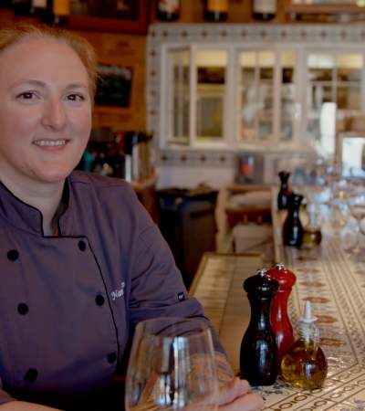 Chef Nancy Alip behind the bar at Jens Restaurant