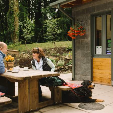 Couple enjoying coffee with pet dog