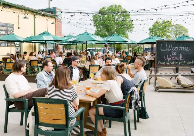 A large group dining on Upland's patio