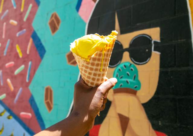 Chocolate Moose ice cream cone held in front of their mural