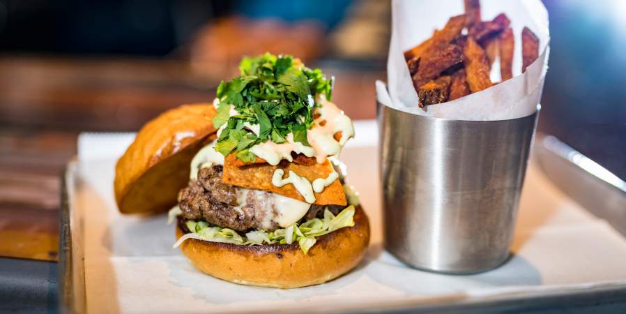 A Cheeseburger with a side of sweet potato fries from Farmer & the Cow.