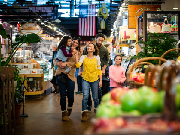 a family walking through the Milwaukee Public Market