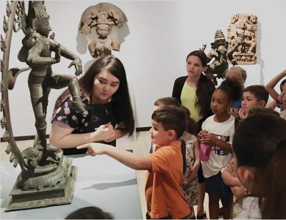 students looking at Buddhist sculpture at the Amarillo Museum of art