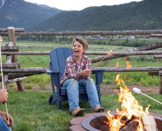 Family enjoying smores around a campfire