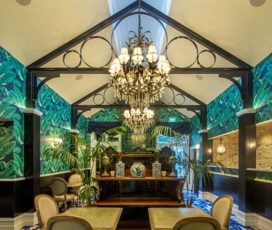 Hulbert House lounge with palm tree decor