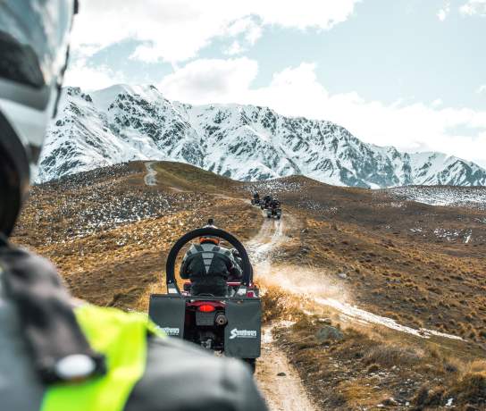 Quad biking on a dirt track at the top of a mountain
