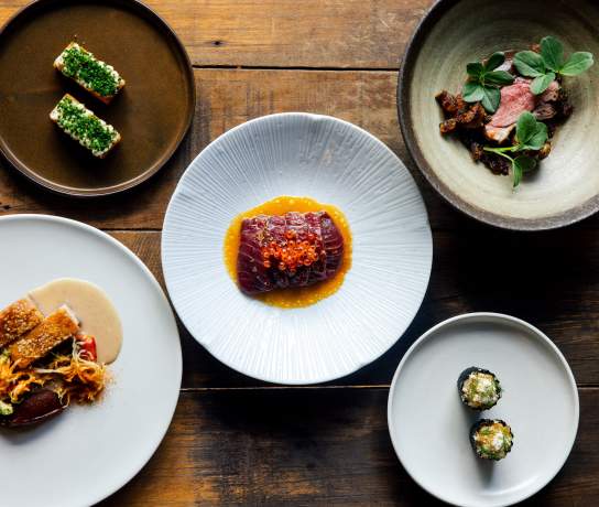Photo of lots of plates with colourul food