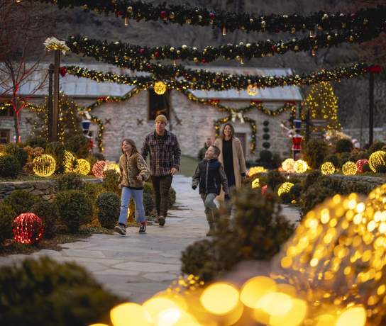 A family walking in among light up decortions
