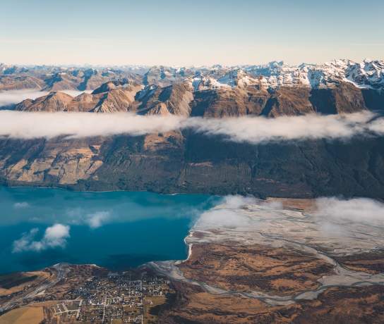 Aerial photo of Glenorchy township with huge mountains in the background