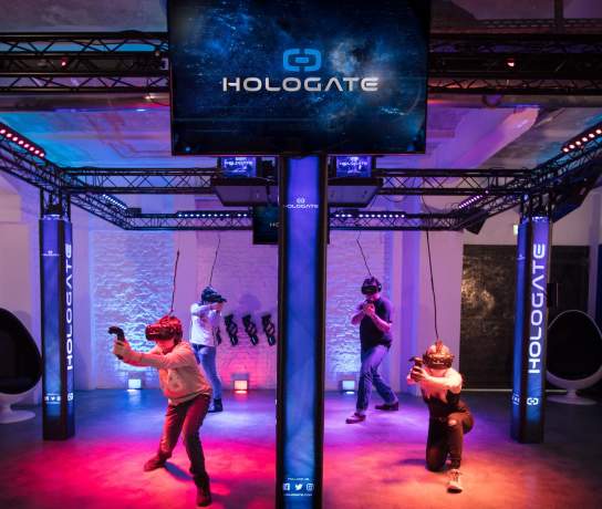 People in a colourful virtual reality area