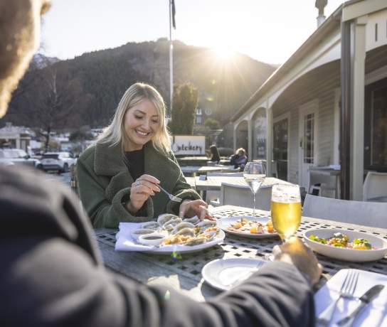 Two people dining outdoors at Botswana Butchery
