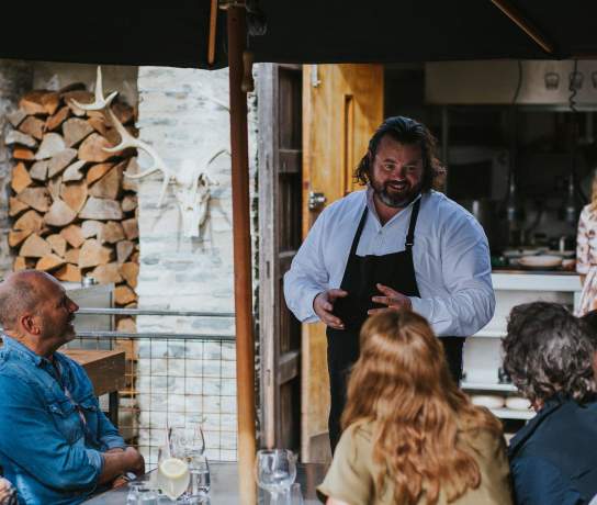 Chef Vaughan Mabee talking with guests, Amisfield