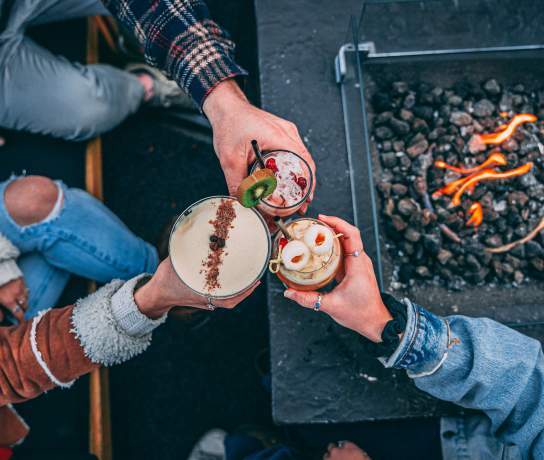Friends drinking cocktails at Sundeck in Winter