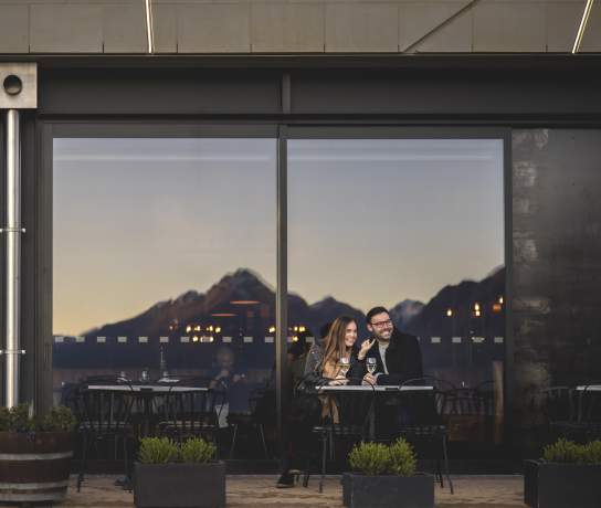 Two people dining out front of The Grille by Eichardt's Restaurant