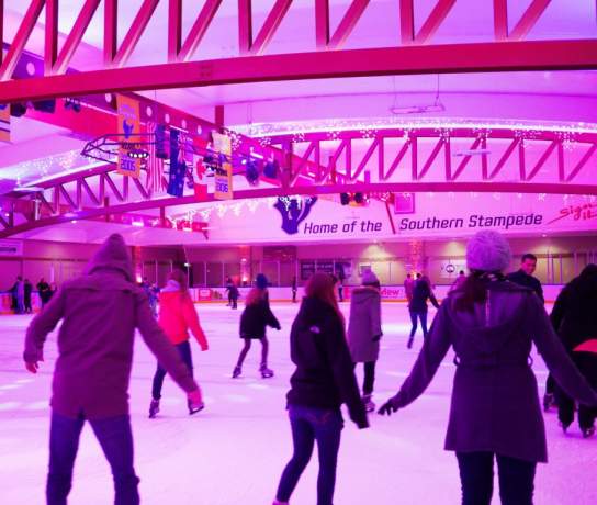 People ice skating at Queenstown Ice Arena