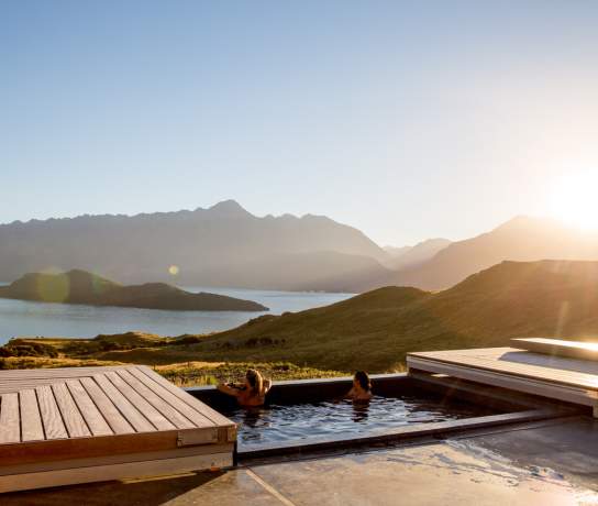 Two women relaxing in the outdoor spa at Aro Ha Wellness Retreat