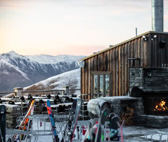 Treble Cone Base Building - a wooden cabin with fire and mountain views