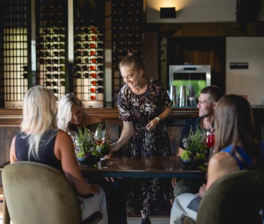 Waitress serving guests at Amisfield Restaurant