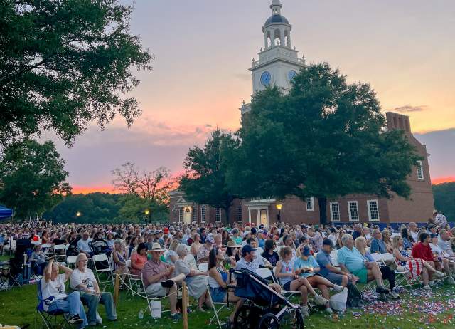 A crowd of people waits for fireworks at the American Village Independence Day Festival.