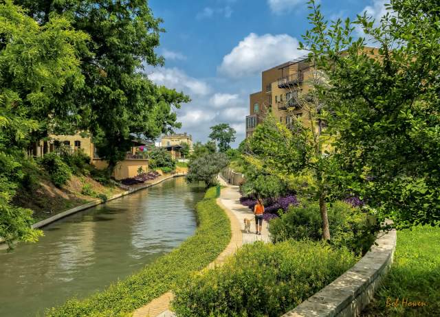 Woman walking dog along Museum Reach of River Walk